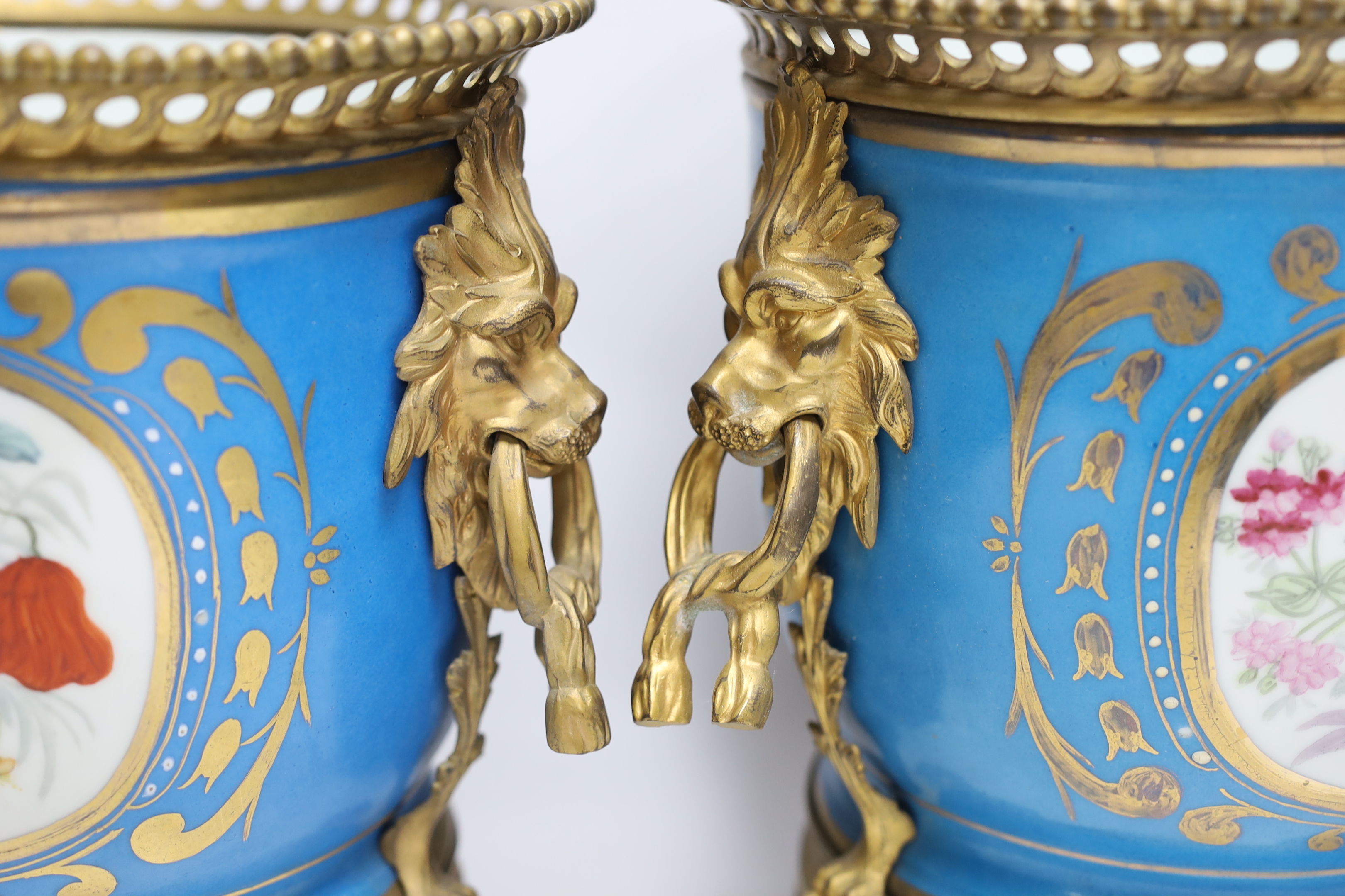 A pair of ormolu mounted Sevres style cache pots, 29cm high